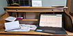 Papers, checkbook and computer on desktop.
