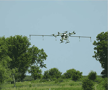 Drone flying over field.